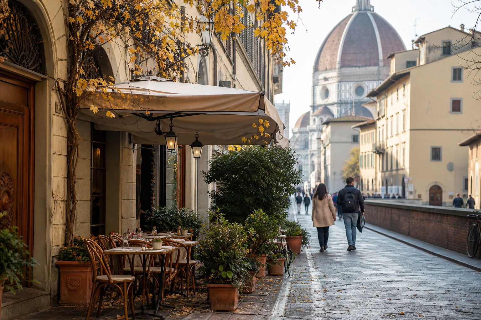 Quiet Florence street on an autumn morning with golden leaves and a café with outdoor tables.